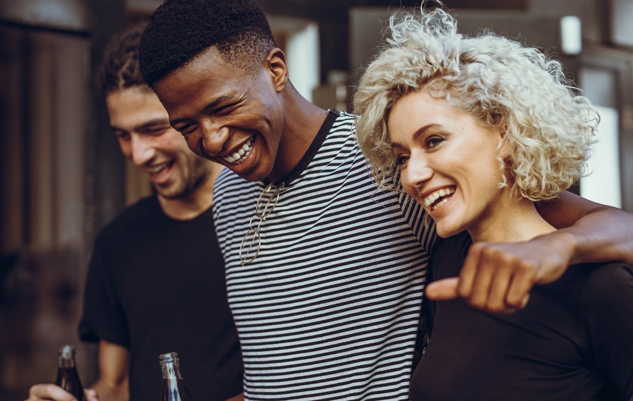 Three people walking together, laughing