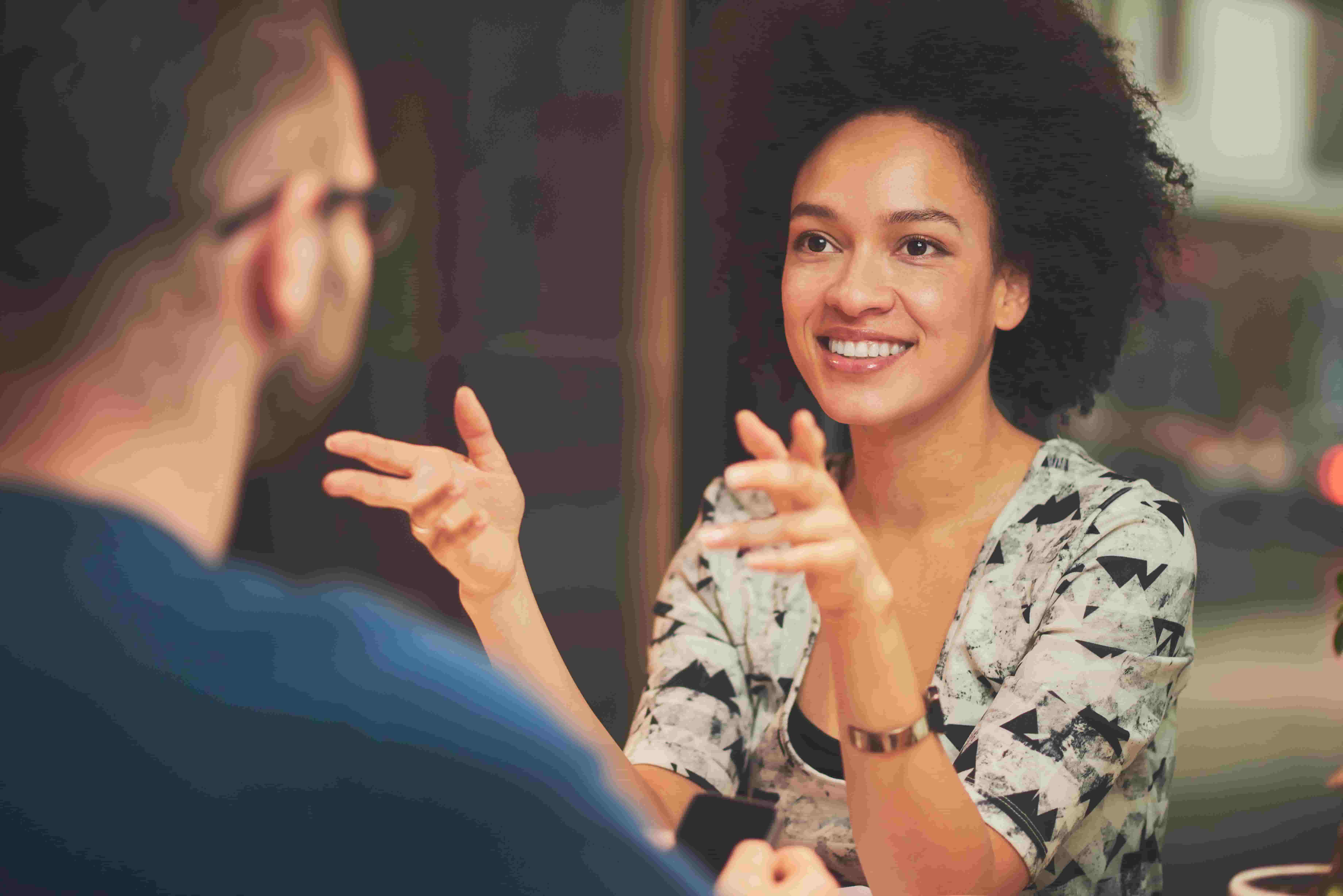 woman talking to someone across the table