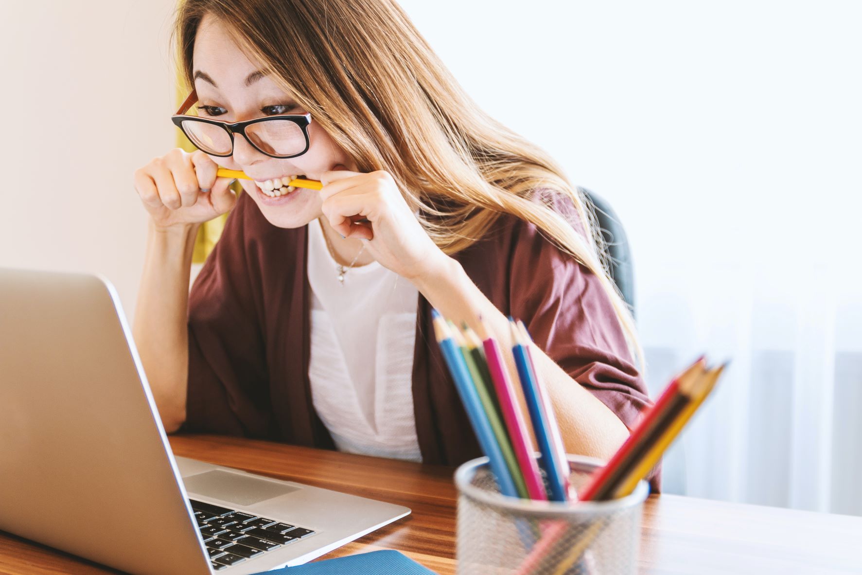 Woman staring at computer screen, looking at credentialing requirements