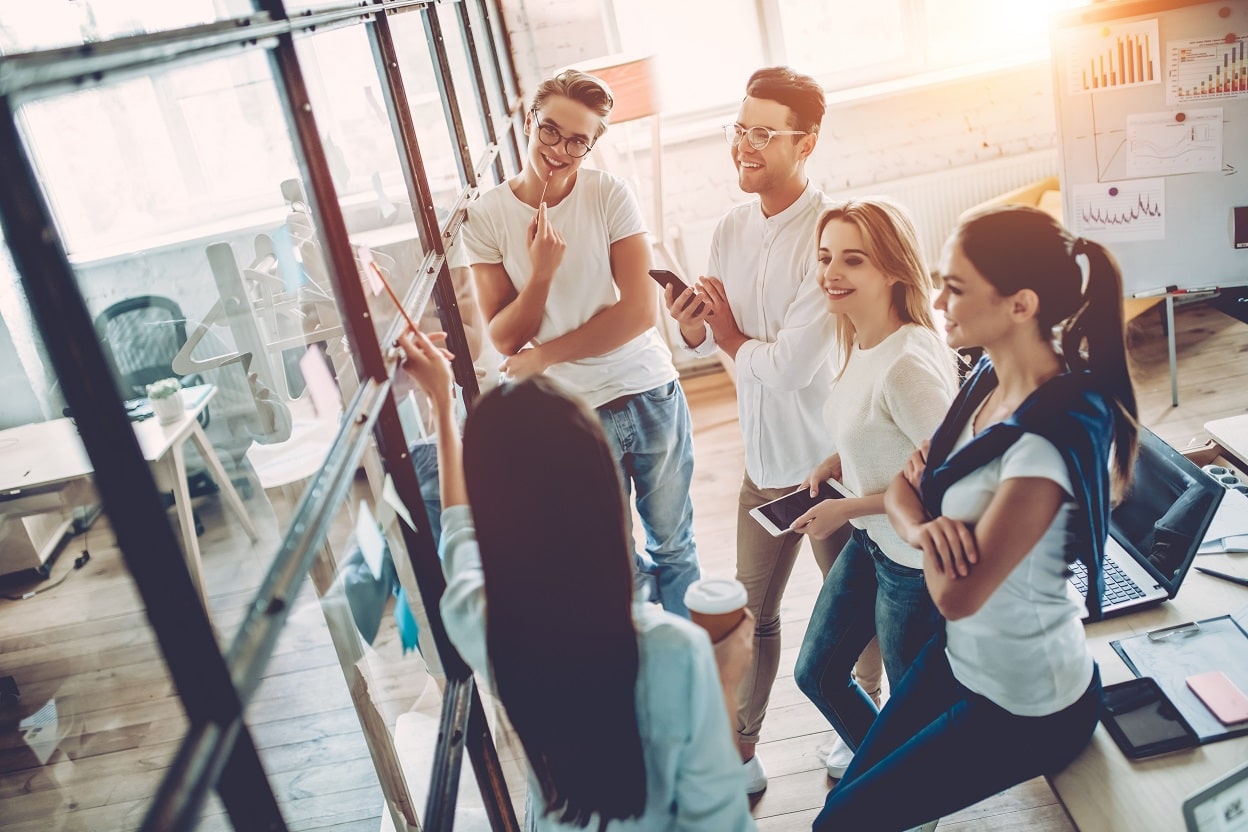 Group of people gathered around an idea board with a consultant
